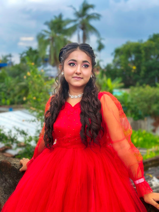 A beautiful woman wears a red dress.