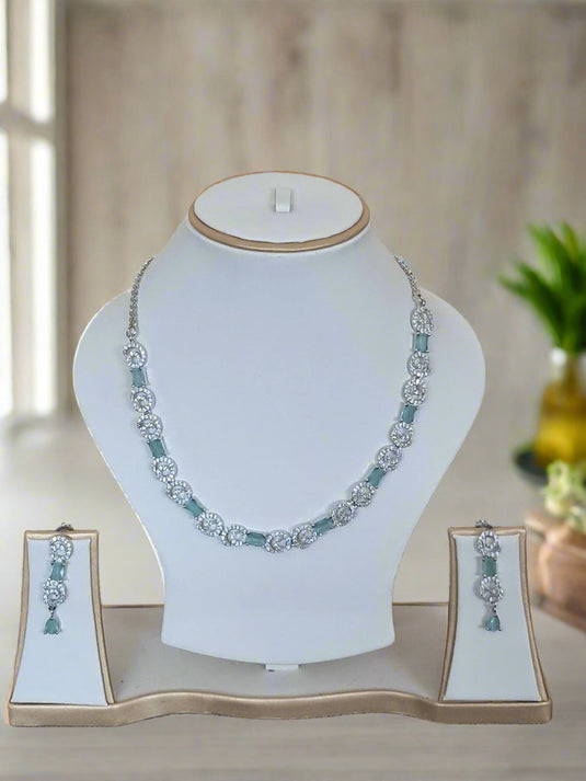 Silver-plated necklace set with aqua green centre stone and American Diamond-style details by GARIMAS.