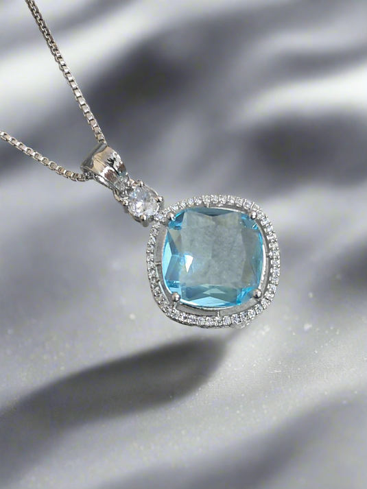 Aqua blue pendant with CZ studs on a silver-plated chain, perfect for any occasion by Garimas.