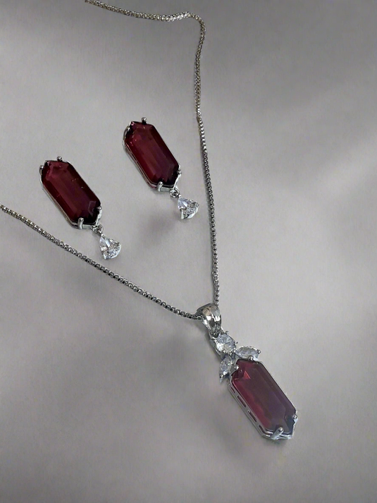 Elegant Garimas pendant set with red ruby and CZ stones on silver-plated chain, perfect for any occasion.