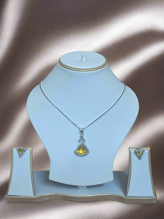 Exquisite Aqua Yellow CZ studded pendant set on display with silver plated chain by Garimas against elegant backdrop.