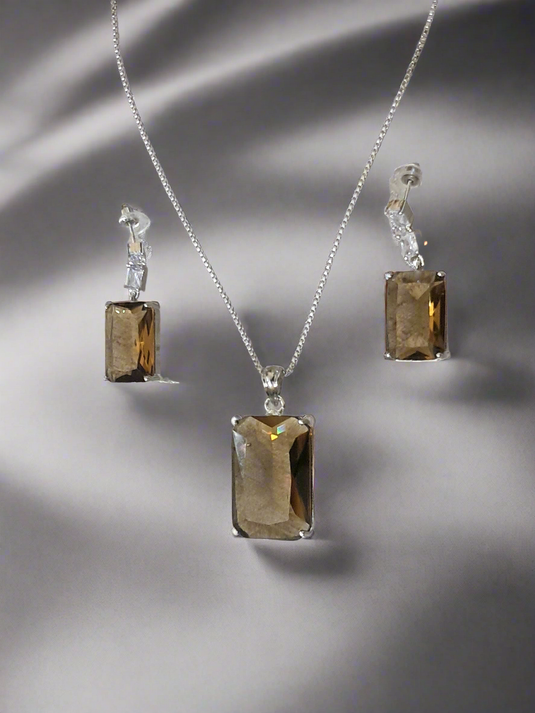 Smoky yellow pendant set with matching earrings and silver-plated chain by Garimas, showcasing elegance and style.