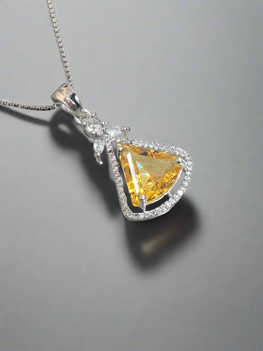 Aqua yellow CZ studded pendant set by Garimas, showcasing a sparkling yellow gem on a silver-plated chain.