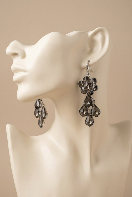 GARIMAS smoky grey floral drop earrings displayed on an ivory mannequin head.