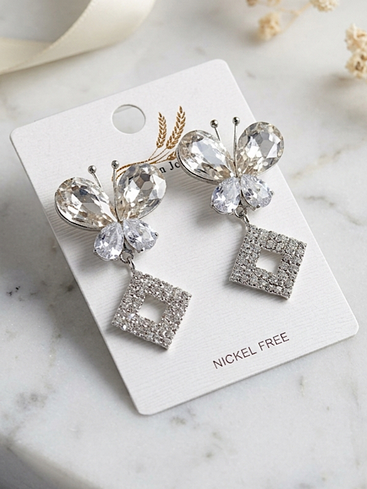 Silver crystal butterfly drop earrings with square rhinestone pendants by GARIMAS.