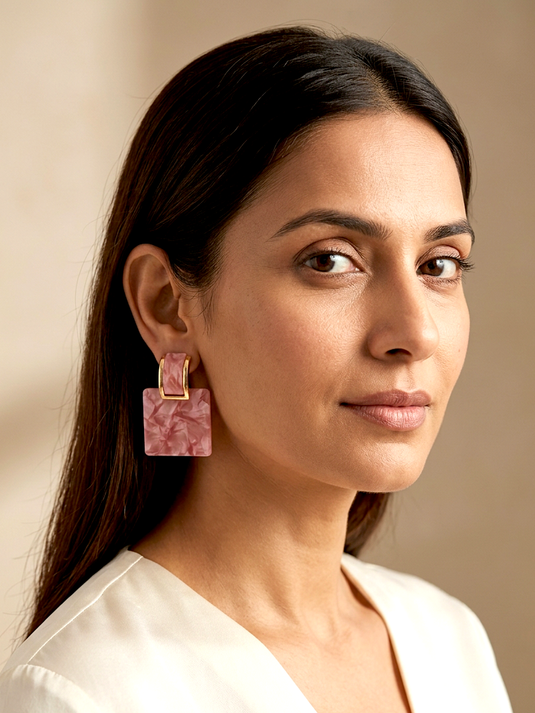 GARIMAS pink marble-effect square drop earrings with gold-tone rectangular tops, shown worn by a model.