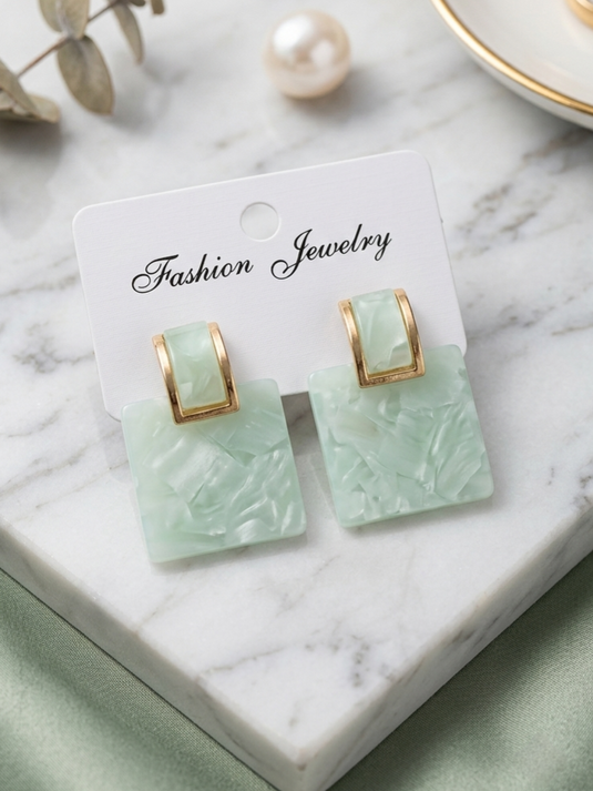 GARIMAS mint green marble-effect square drop earrings with gold-tone rectangular tops on a jewellery display card.