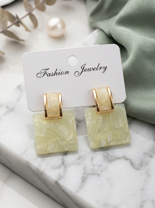 GARIMAS butter yellow marble-effect square drop earrings with gold-tone rectangular tops on a jewellery display card.