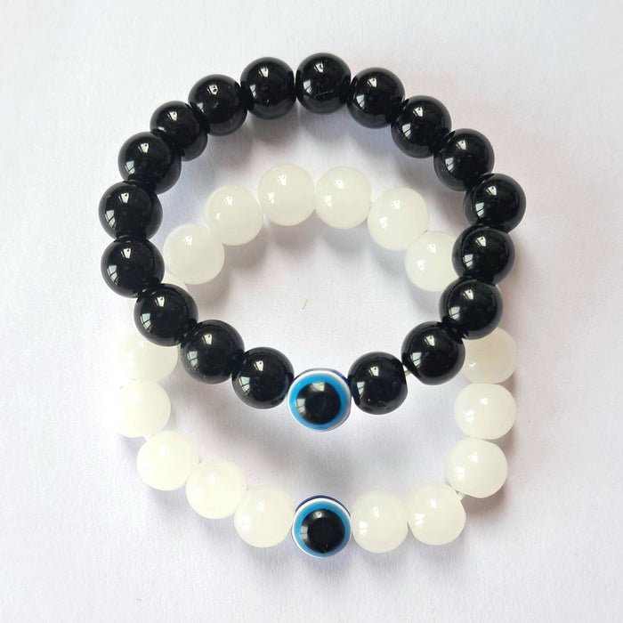 Two-piece stretchable black and white glass bead evil eye Nazariya charm bracelet by GARIMAS.