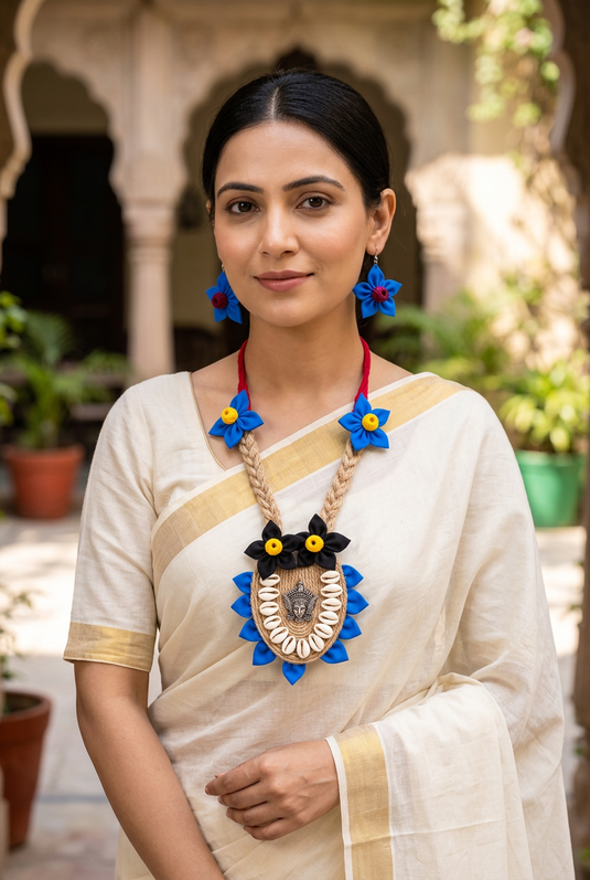 Indian woman wearing GARIMAS jute-look necklace with blue and black flowers and matching earrings